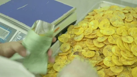 Weighing chip packets Stock Footage 77099938