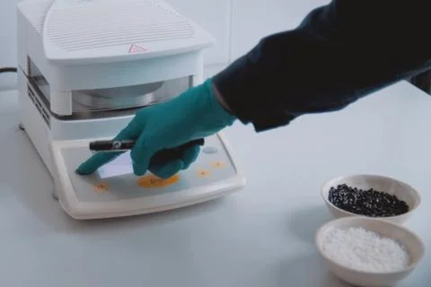 Weighing the components of explosive on electronic scales. Stock Photos
