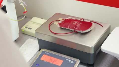 Weighing a container of blood Stock Footage 234813946