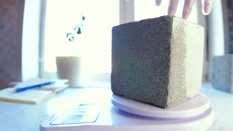 Weighing a cube of foam concrete in the laboratory Stock Footage 263154013