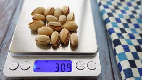 Weighing pistachios for perfect portion control at home Stock Footage 304436333