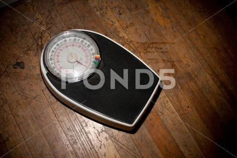 Weighing Scales On Wooden Floor