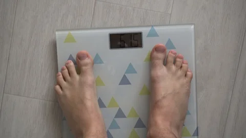 Weighing a thin man Stock Footage 127840222