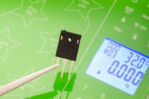 Weighing a transistor on a scale Stock Photos