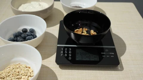 Weighing Walnut Kernels for a Healthy Breakfast Topping Stock Footage 340960395