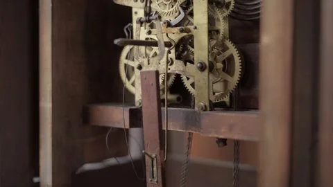 Weight chain pulled on gears of old grandfather clock Stock Footage 341636872