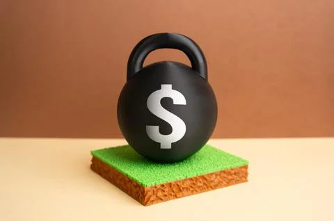 A weight with a dollar misplaced on a plot of land. High land value and inves Stock Photos