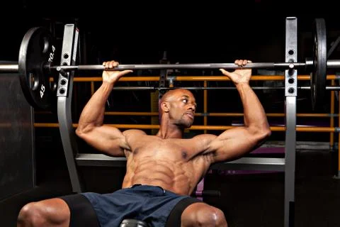 Weight lifter at the bench press about to lift a barbell. Stock Photos