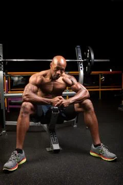 Weight lifter sitting at the bench press about to lift a barbell. Stock Photos