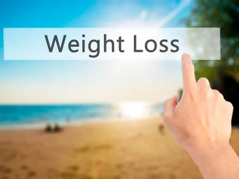 Weight Loss - Hand pressing a button on blurred background concept on visual  Stock-Fotos