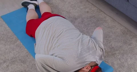 Weight loss workout of obese man doing push ups from mat, bodyweight exercise Stock Footage 331564180