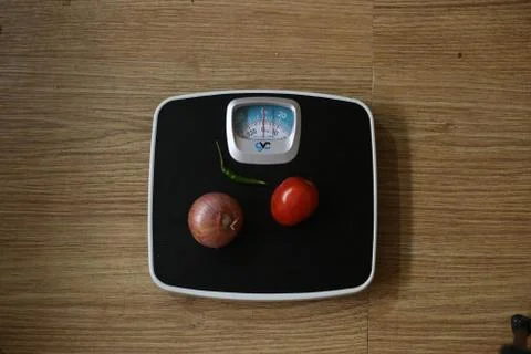 Weight machine concept, Vegetables on the weight machine Stock Photos
