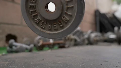Weight plate dropped slow motion in gym Stock Footage 163770641