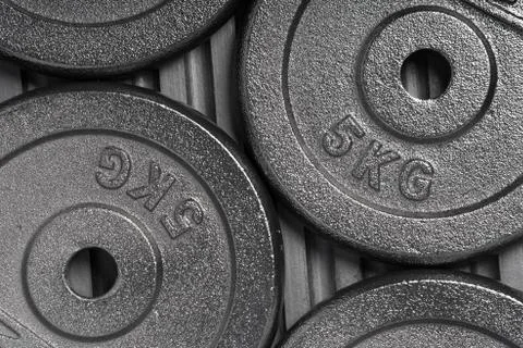 Weight plates inside a weight training gym / fitness studio Stock Photos