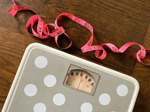 Weight scale and measuring soft tape close up image. Fitness and weight loss Stock Photos