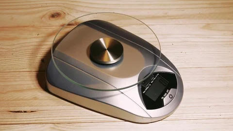 Weighting marijuana on a scale Stock Footage 79954635