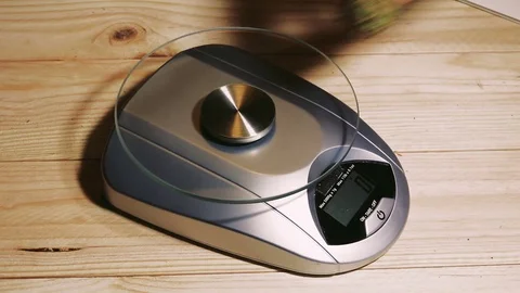 Weighting marijuana on a scale Stock Footage 79955032