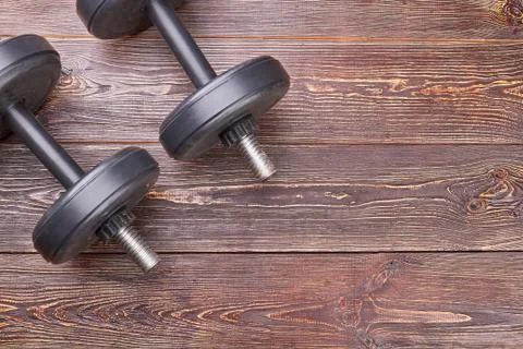 Weightl ifting objects on wooden floor. Stock Photos