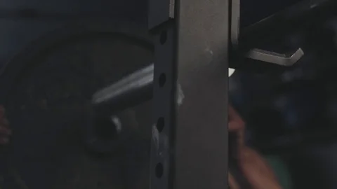 Weightlifter adding weight to bar Stock Footage 76724616