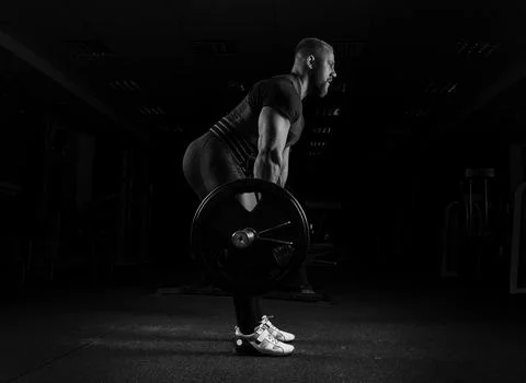 The weightlifter performs an exercise called deadlift. Stock Photos