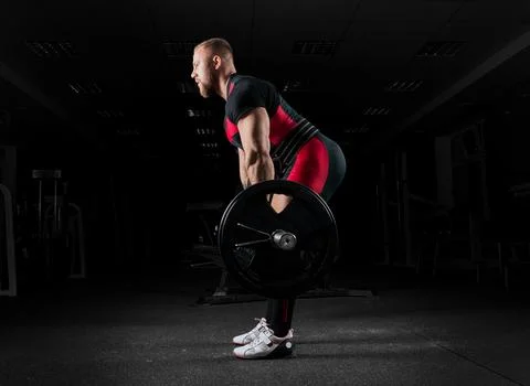 The weightlifter performs an exercise called deadlift. Stock Photos