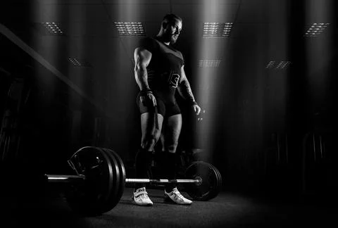 The weightlifter is preparing to perform an exercise called deadlift. Stock Photos