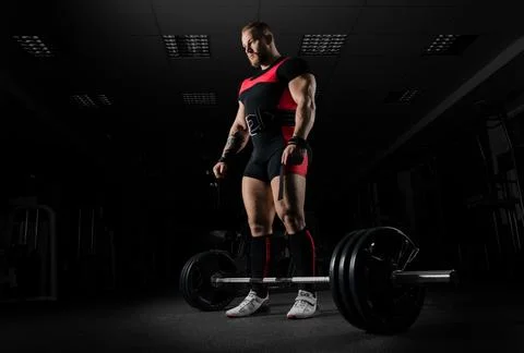 The weightlifter is preparing to perform an exercise called deadlift. Stock Photos