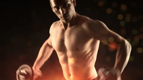 Weightlifting dumbbell at a gym body Building workout 4k with black background Stock Footage 100454341
