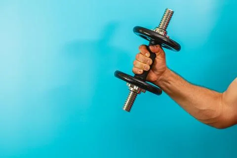 Weightlifting exercise with a dumbbell in a workout setting Stock Photos