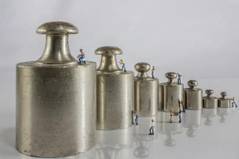 Weights for balance with miniature workers Stock Photos
