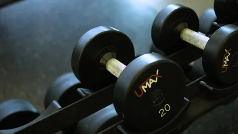 Weights on a rack in a gym Stock Footage 130257432