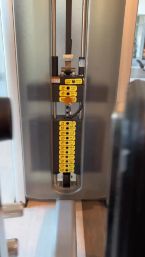 Weights rising and falling from the inner outer thigh machine weight stack Stock Footage 317333317