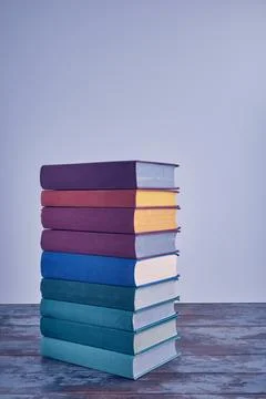 A weighty stack of bright smart books in textural fabric multi-colored cove.. Stock Photos