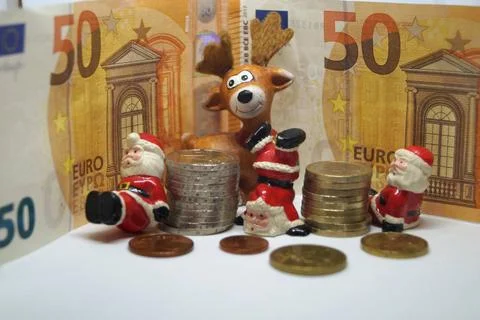 , Weihnachtsmaenner, Elch und Euros, Symbolbild Weihnachtsgeld Santa Claus... Stock Photos