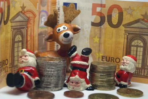 , Weihnachtsmaenner, Elch und Euros, Symbolbild Weihnachtsgeld Santa Claus... Stock Photos