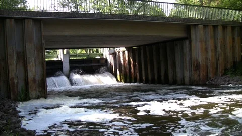 Weir and bridge with polluted and foamy river water with audio Stock Footage 88595135