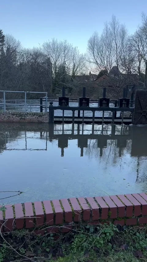 Weir and floodgate controlling River Brett water levels in Suffolk, UK Stock Footage 326237325