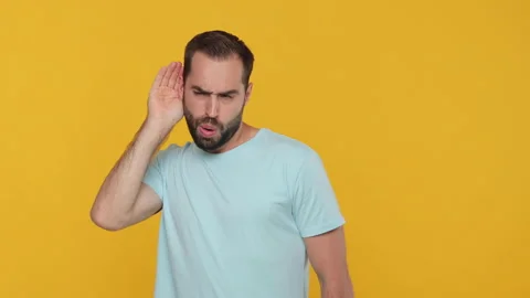Weird fun bearded young man 20s in basic casual blue t-shirt isolated on yellow 動画素材 148283130