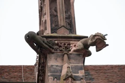 Weird gargoyle on the side of the munster where the water flows out the rear Stock Photos