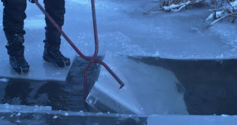 Weissensee lac cutting ice bis getting the ice out of the water04054262 Stock Footage 264973077