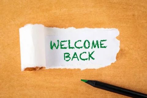 Welcome back. Text under torn paper. Green pencil Foto stock