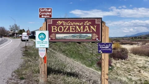 Welcome to Bozeman entry sign with Softball Complex, Tree City USA and Bicycle Stock Footage 337691708