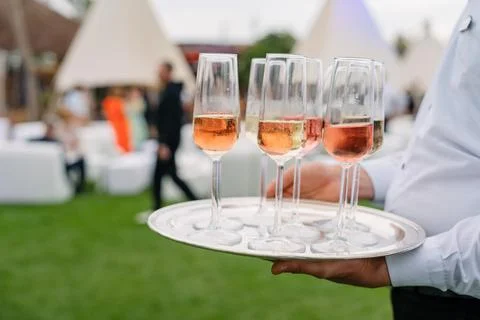 Welcome champaigne by waiters Stock Photos