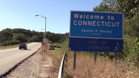 Welcome to Connecticut Sign with traffic passing Stock Footage