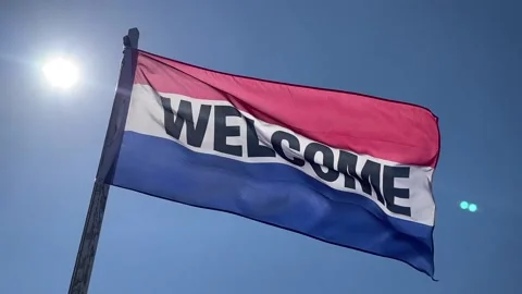 Welcome flag with red, white and blue colours and bright sun Stock Footage 153843201