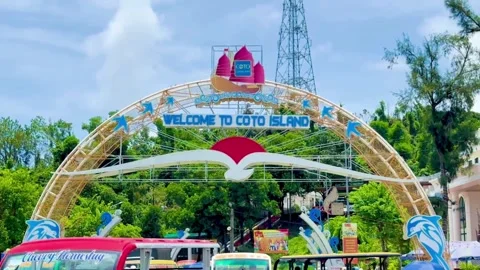 Welcome gate of Co To island with electric cars picking up tourists at the Stock Footage 327802478