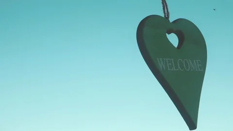 Welcome Heart Shaped Pendulum Moving With The Wind In Slow Motion 스톡 동영상 118190381