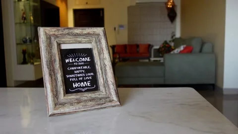 Welcome Home Decorative Frame Displayed in Cozy Living Room Interior Stock Footage 346534588