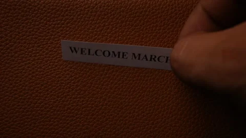 Welcome March Greeting Note on Brown Leather Texture Background Stock Footage 338240340