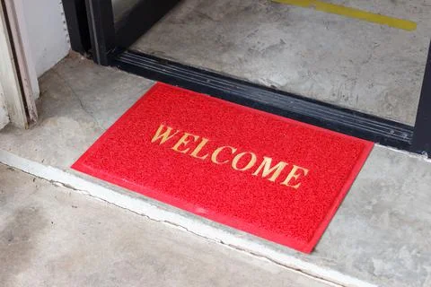 Welcome mat in shop front of door. Stock Photos